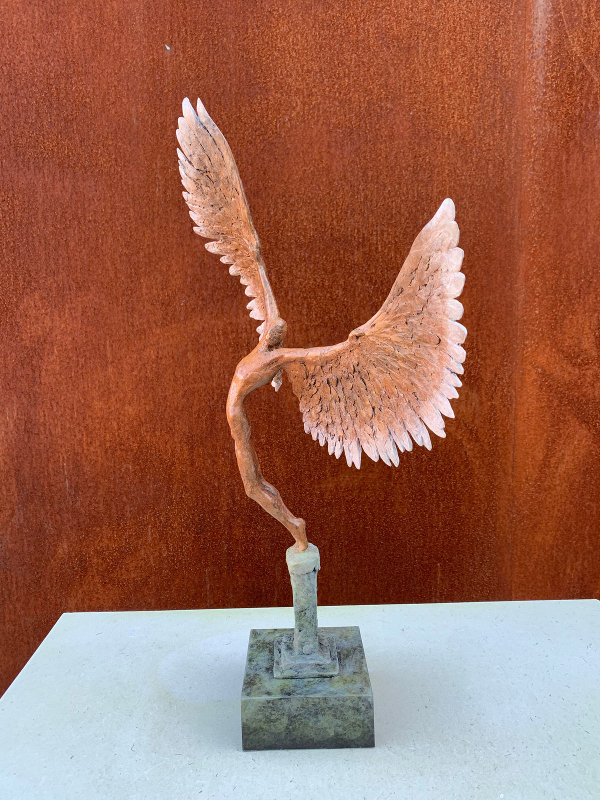 Bronze sculpture of mythical Greek winged figure Icarus by Nicola Godden, displayed on integral plinth