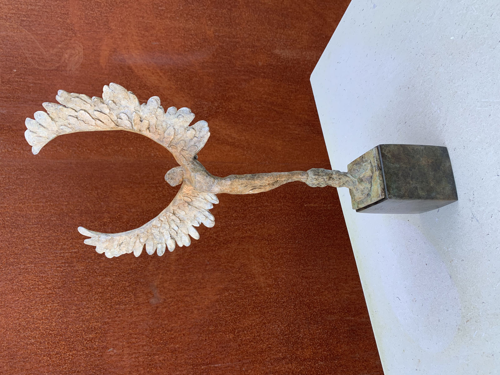 Bronze sculpture of mythical Greek winged figure Icarus by Nicola Godden, displayed on plinth