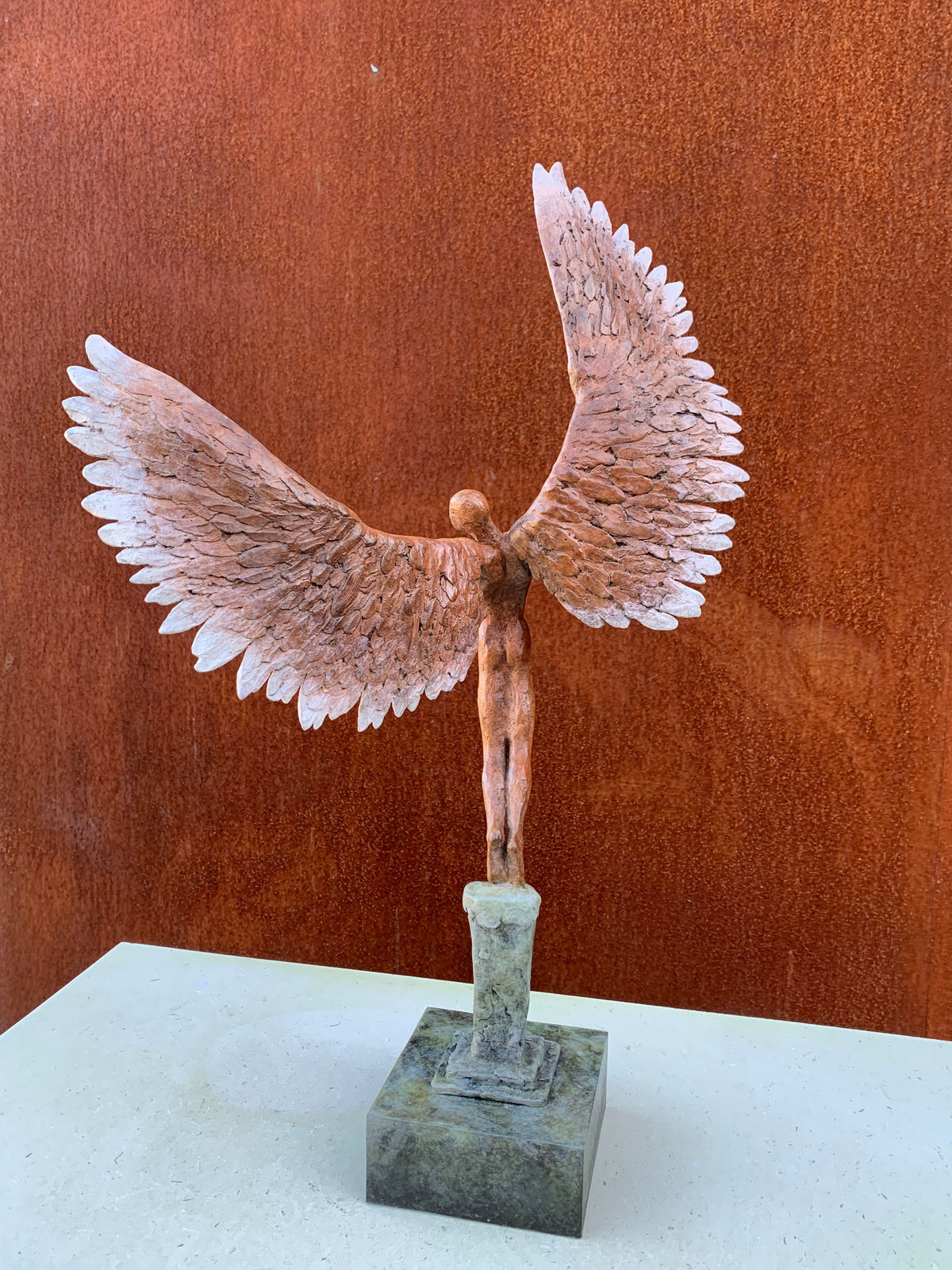 Bronze sculpture of mythical Greek winged figure Icarus by Nicola Godden, displayed on integral plinth