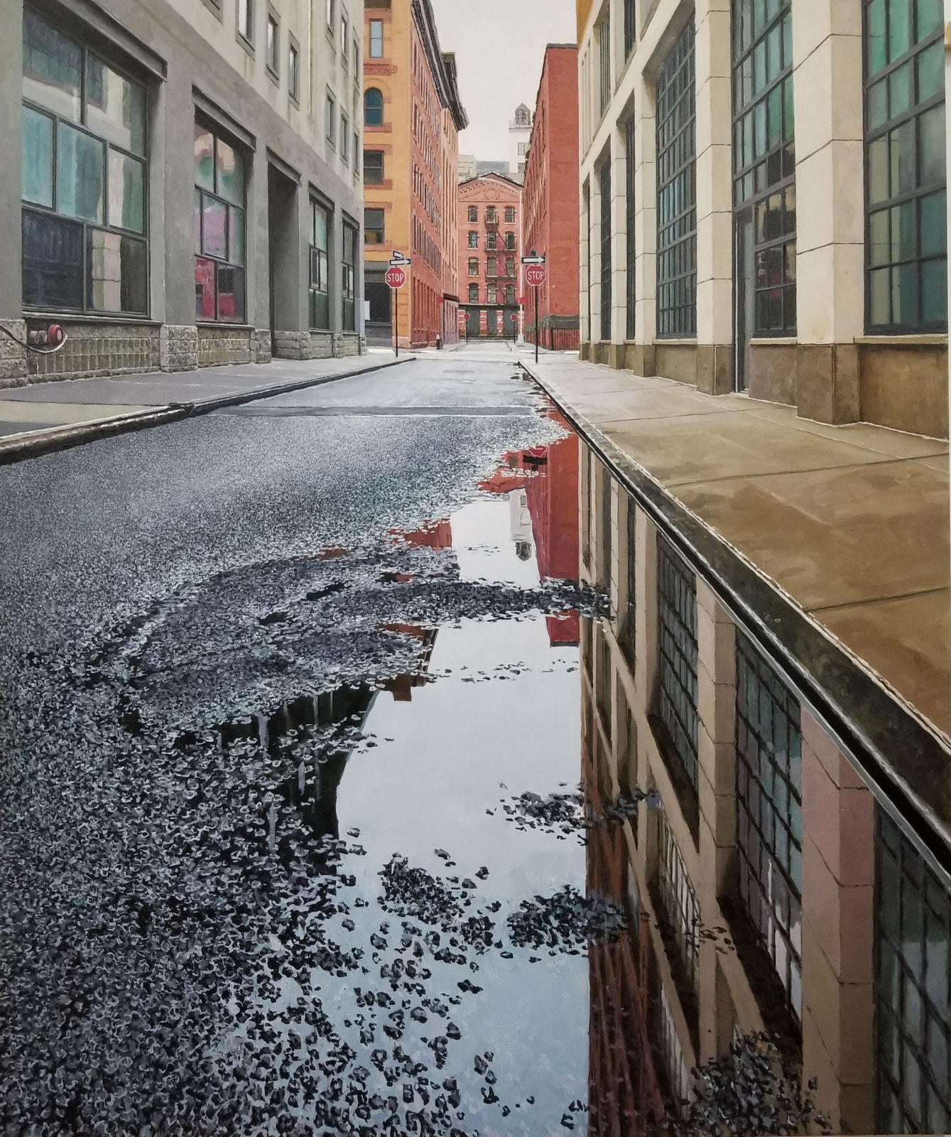 View from ground of puddle on Collister street reflecting grey sky