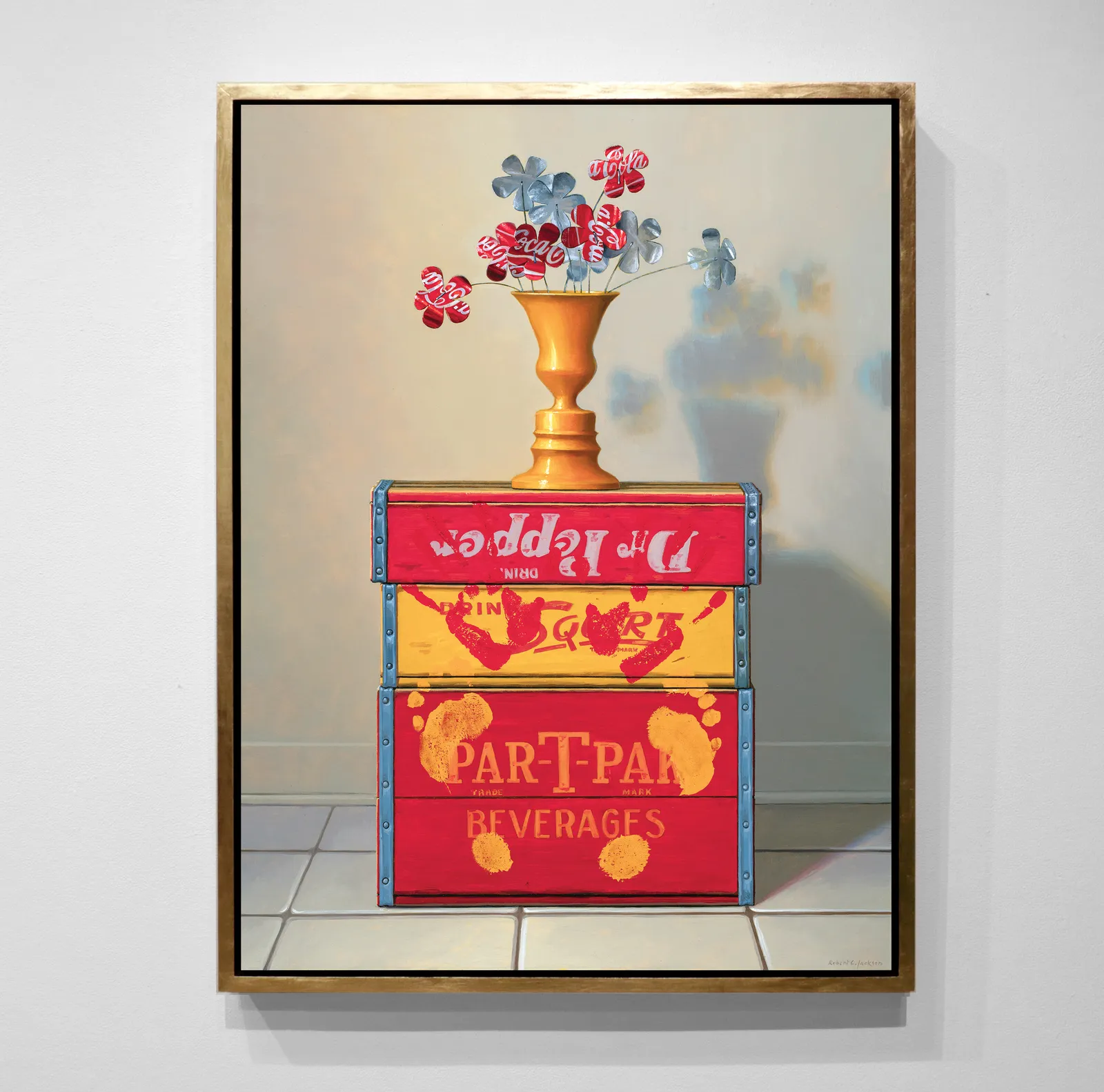 Flowers made from Coca Cola cans on top of red and yellow soda boxes with hand and foot prints