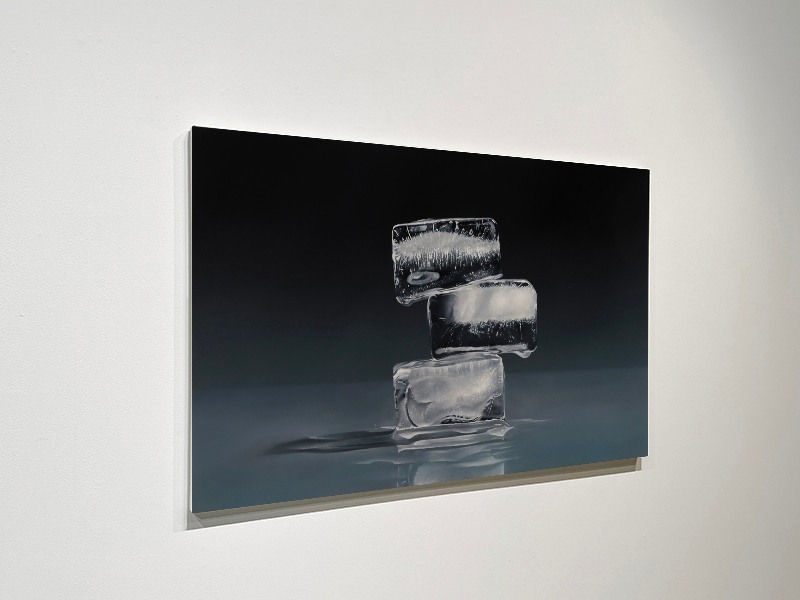 3 Ice cubes stacked off center with grey and blue background