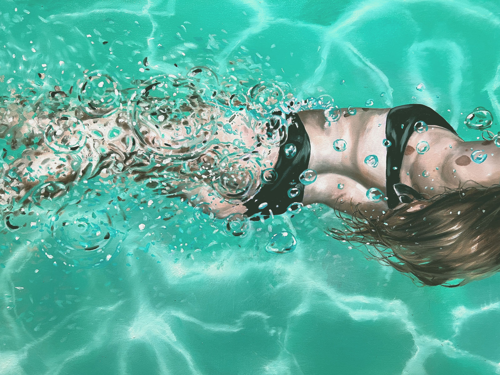 Woman in black bikini swimming in a pool