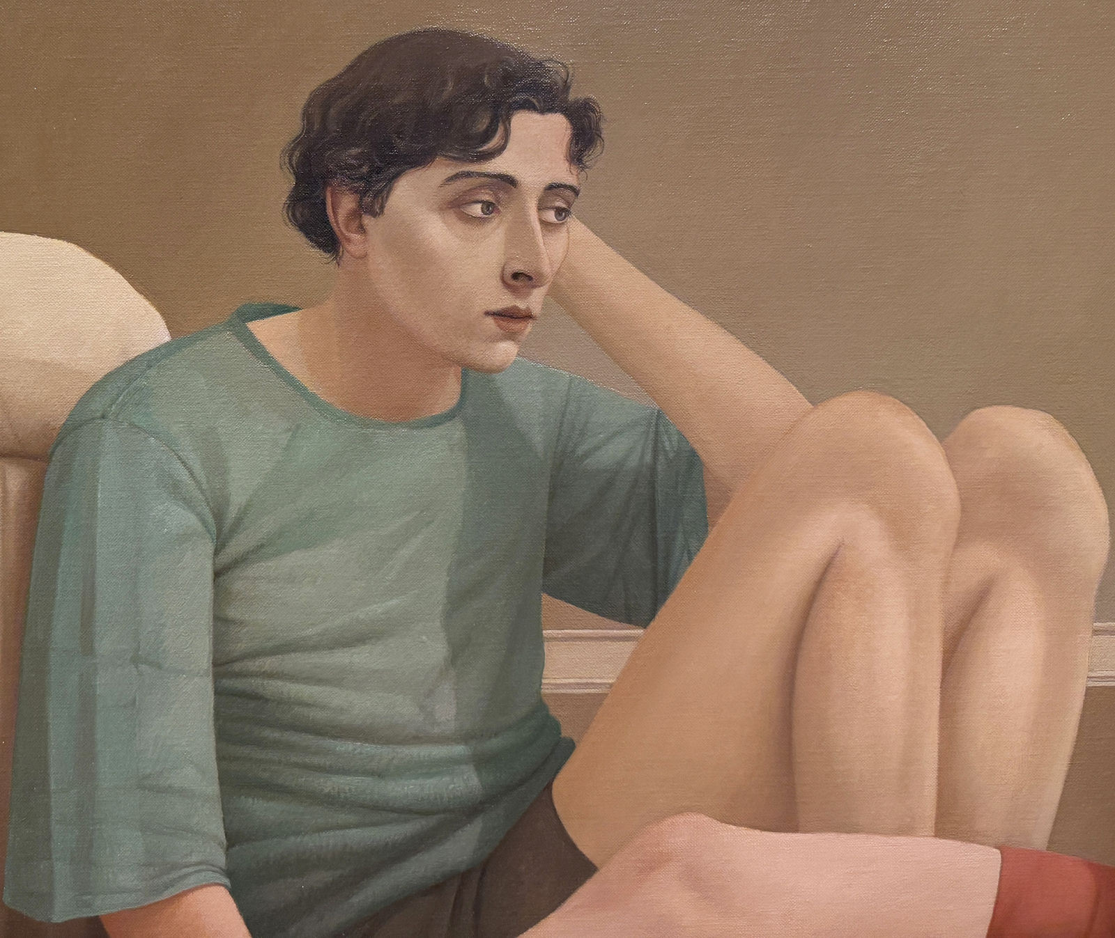 Man in a blue shirt and a woman in a red dress sitting on a bedroom floor