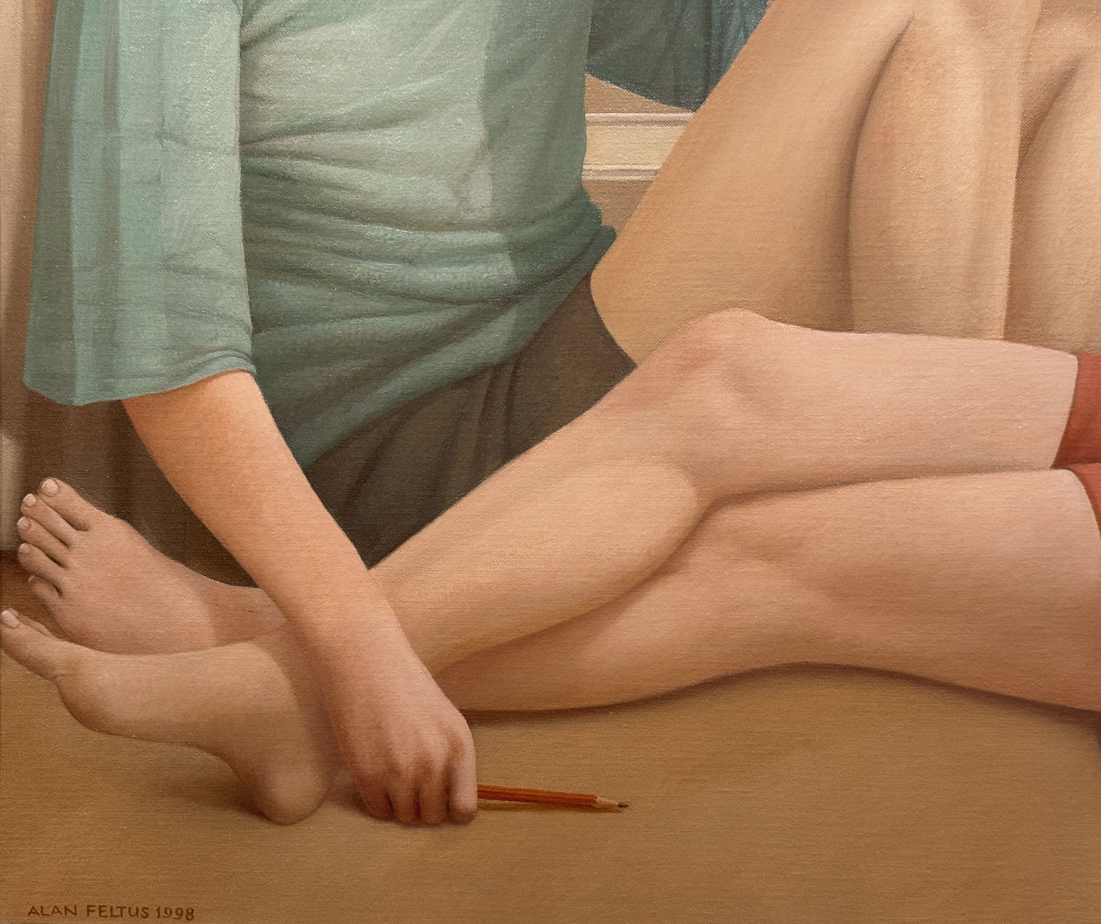 Man in a blue shirt and a woman in a red dress sitting on a bedroom floor