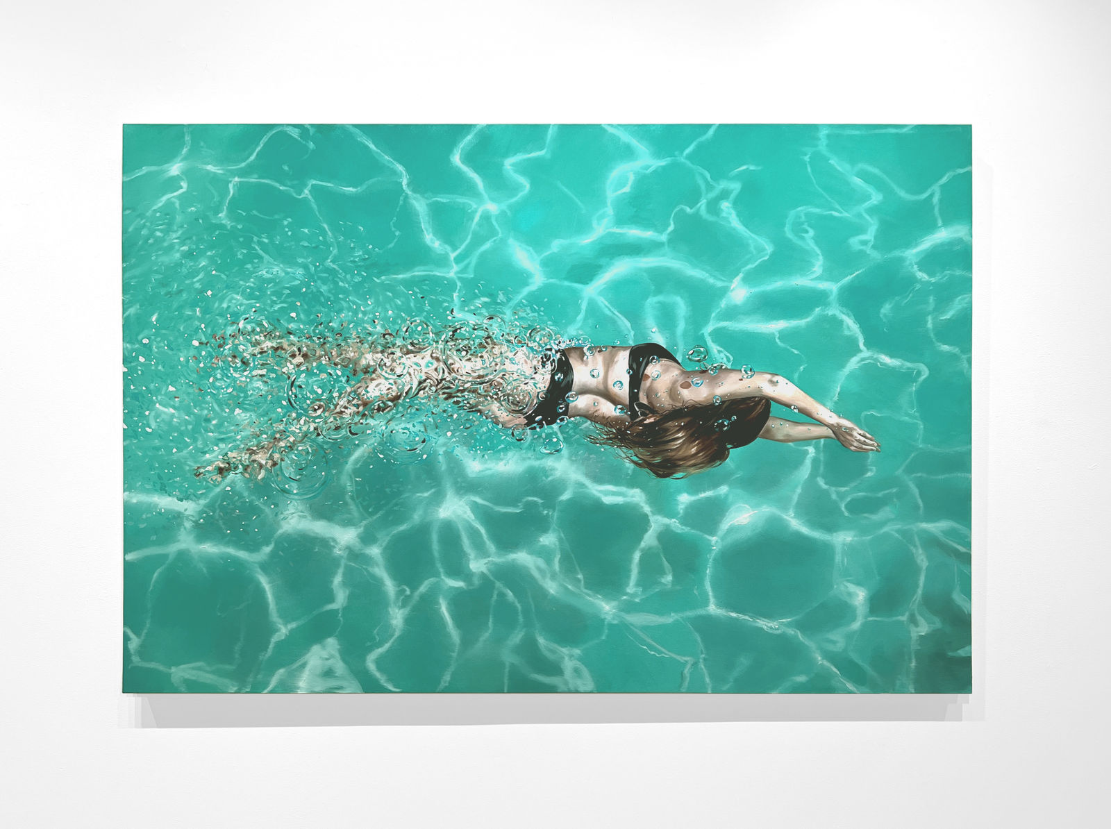 Woman in black bikini swimming in a pool