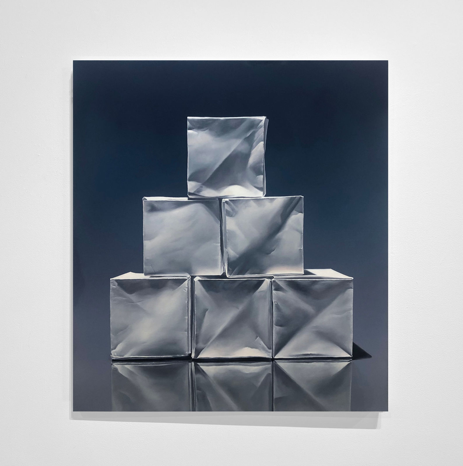 Pyramid of origami paper boxes before dark blue background