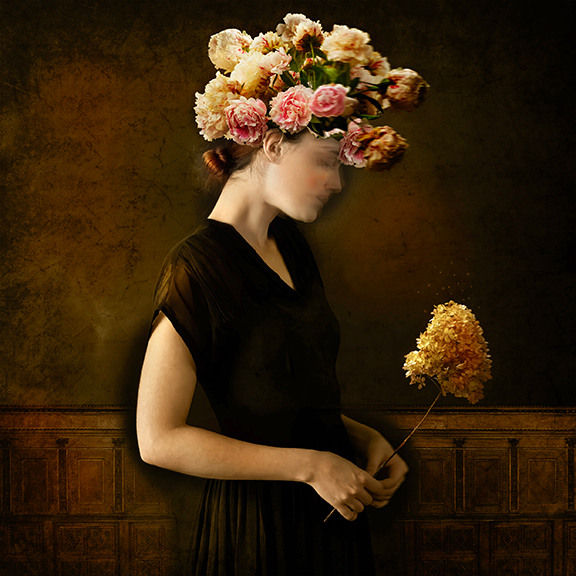 Tom Chambers Archival pigment print of a woman holding flowers, with flowers on her head looking down