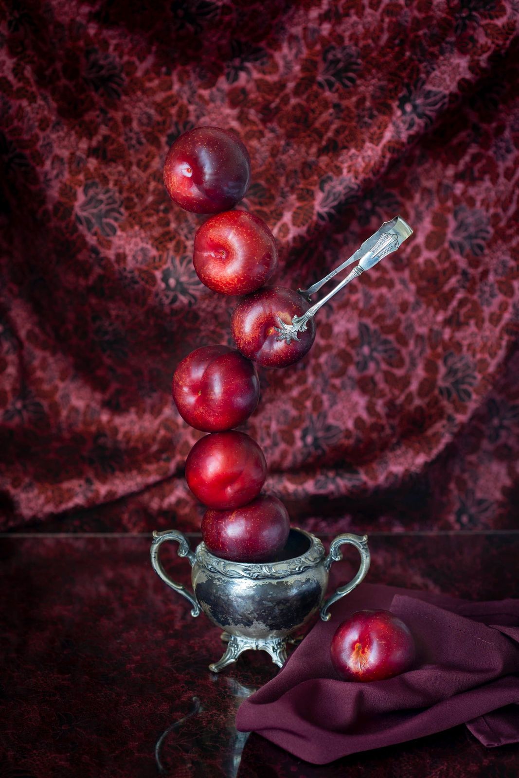 rjp terlizzi photo plums balanced on top of sugar bowl