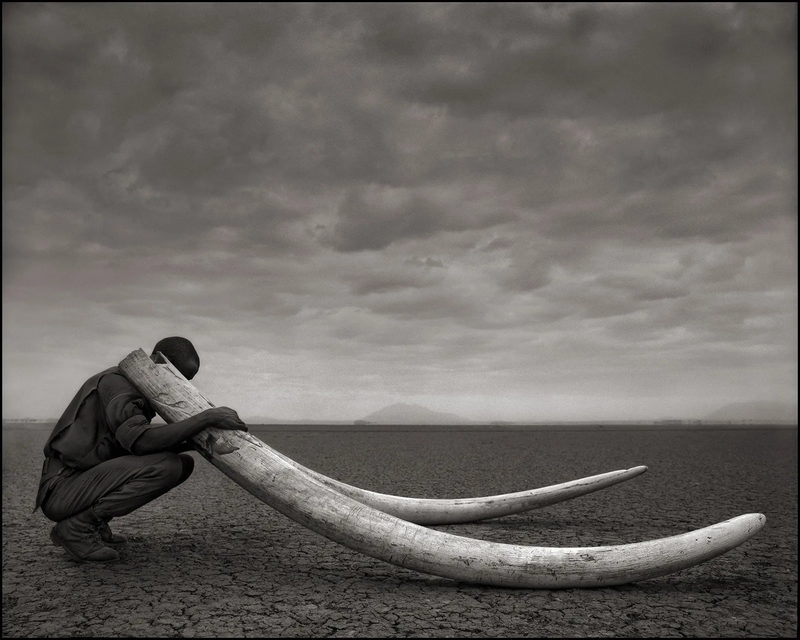 Ranger with tusks nick brandt amboseli