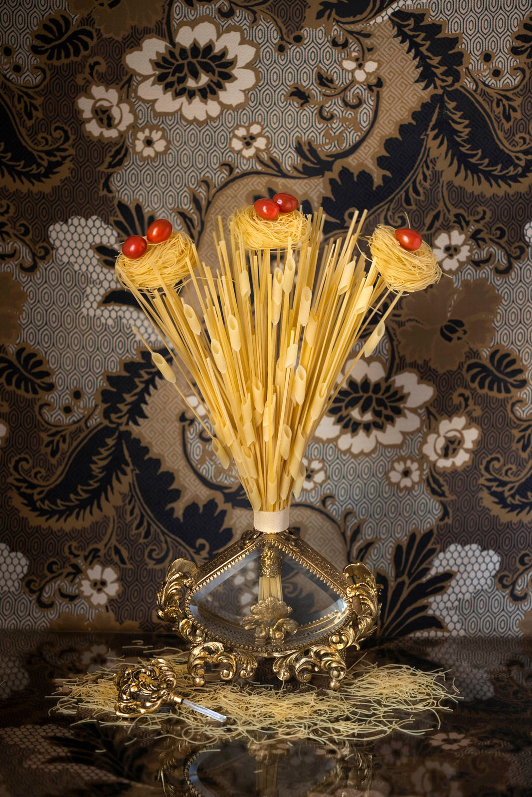 photo of pasta made to look like straw with cherry tomatoes on top