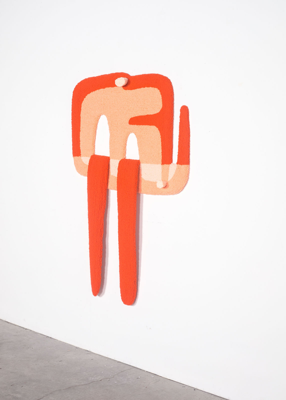 orange tufted rug in an irregular shape