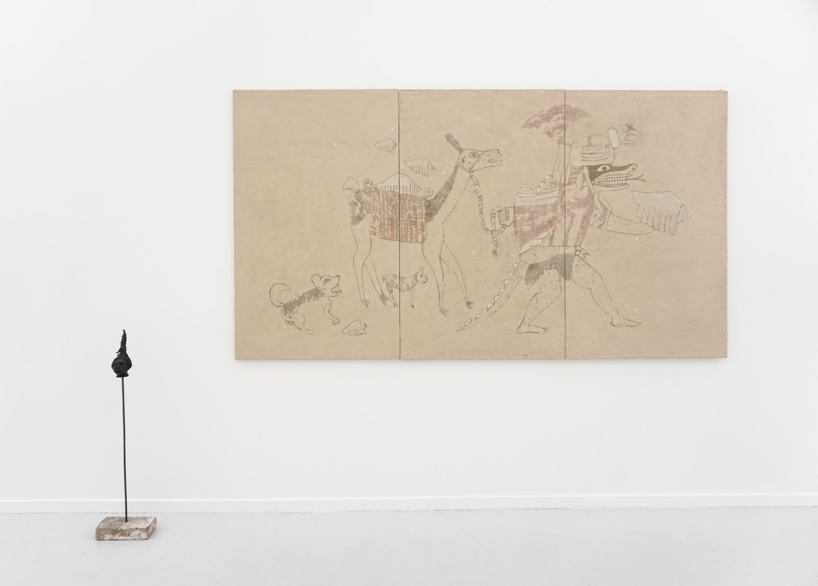 A mixed media clay and ceramic painting hanging on a white wall