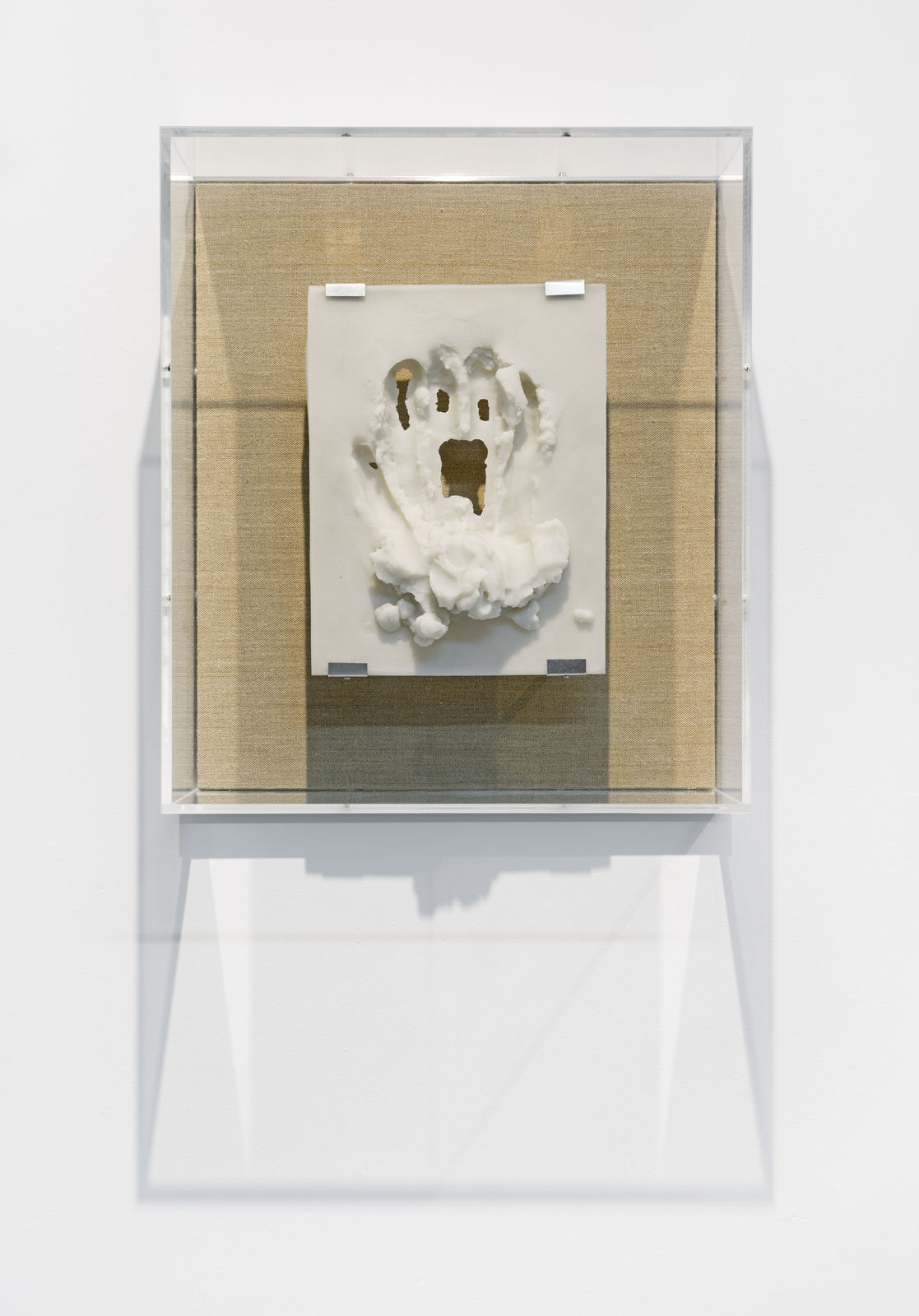 A mixed media piece in a glass case.