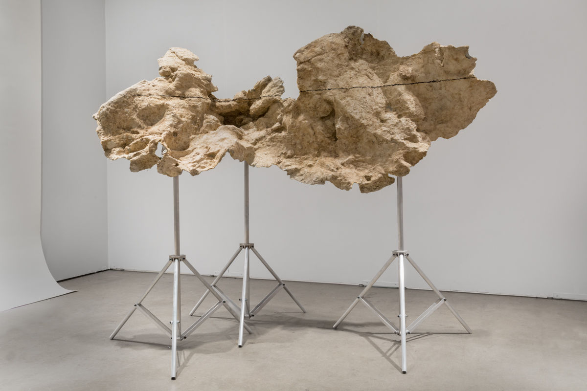 A mixed media sculpture resembling a chuck of rock.