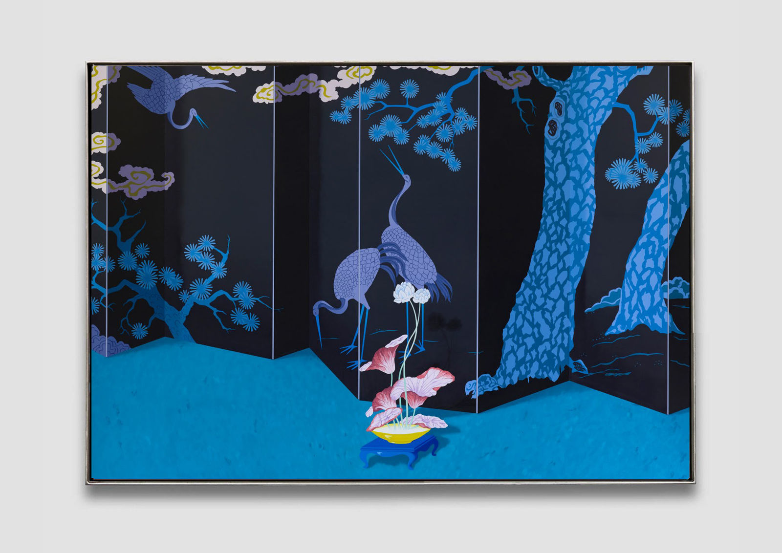 A plant sitting on a blue floor situated in front of a large Chinese divider featuring an assortment of traditional illustrations of animals and plants.