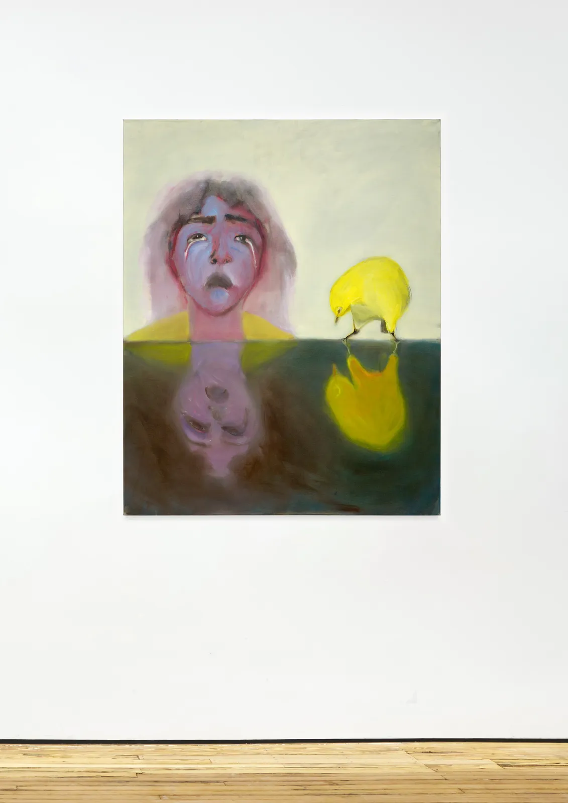 installation image of an oil painting depicting a crying woman and a yellow bird reflected onto a surface
