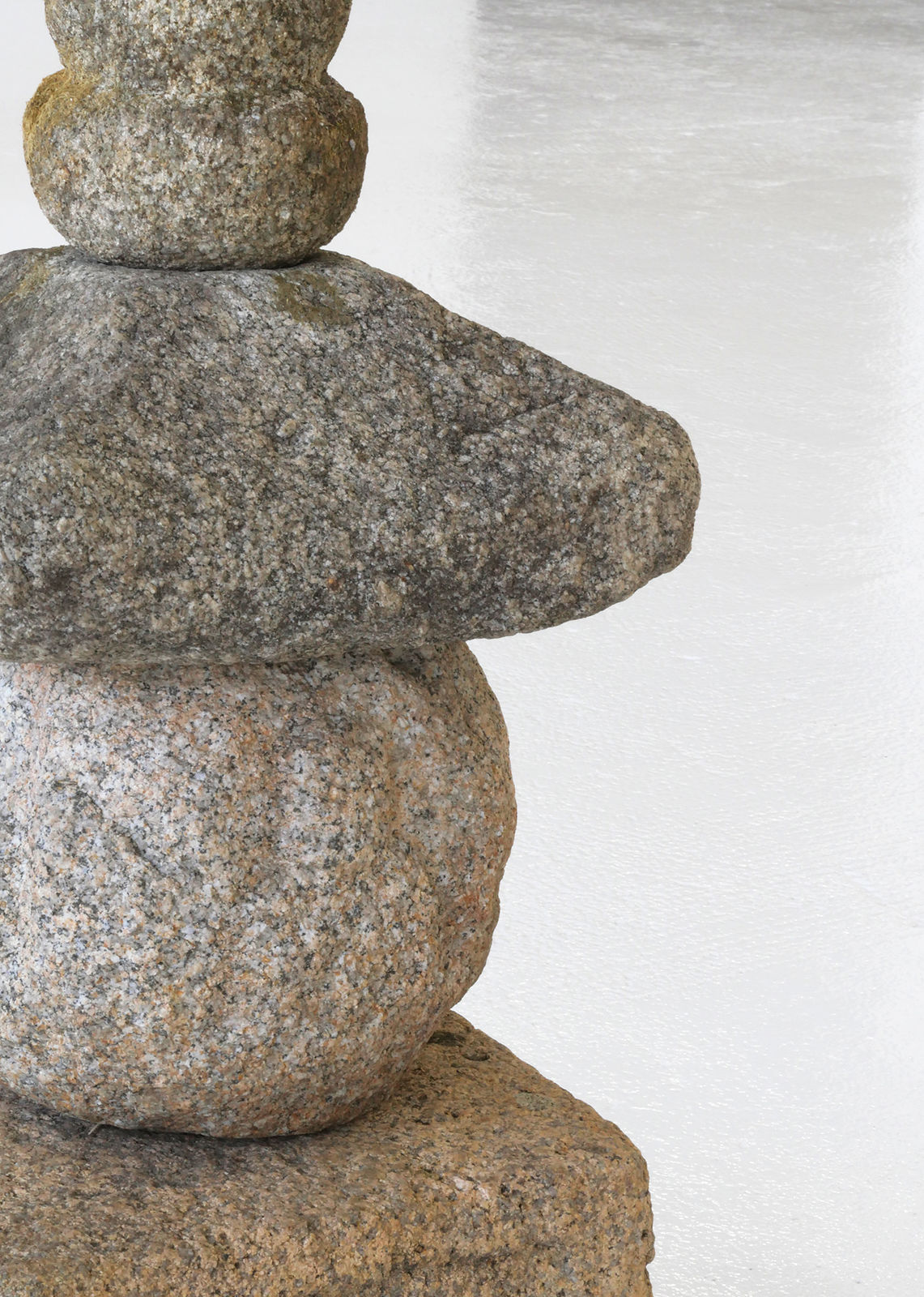 Round body of stone sculpture with sloped top.