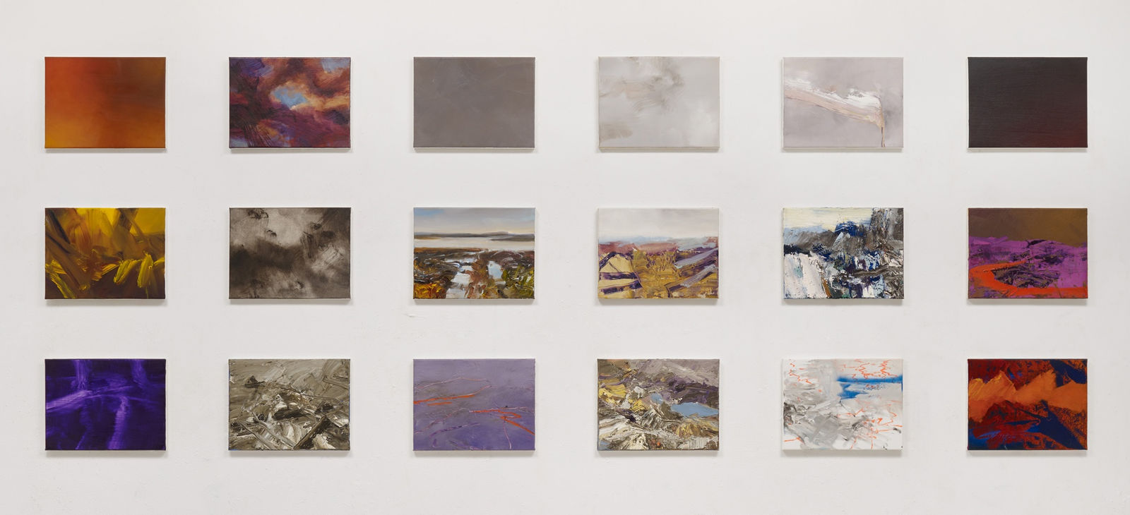 18 small rectangular panels arranged in a grid of three rows and six columns. Each panel has a distinct abstract or landscape scene. The panels are mostly in shades of red, gray and purple. Together the panels make a singular abstract landscape composed of sky on the top row, horizon in the middle, and earth on the bottom row.