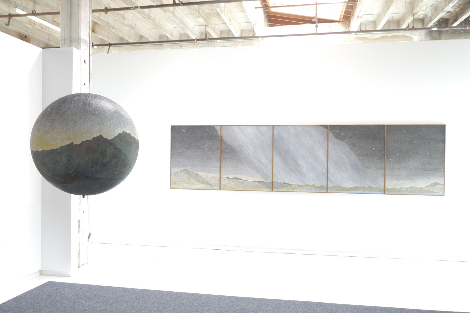 Installation view of Auriga Over Western Ridges with It's Different Up Here hanging in the background.