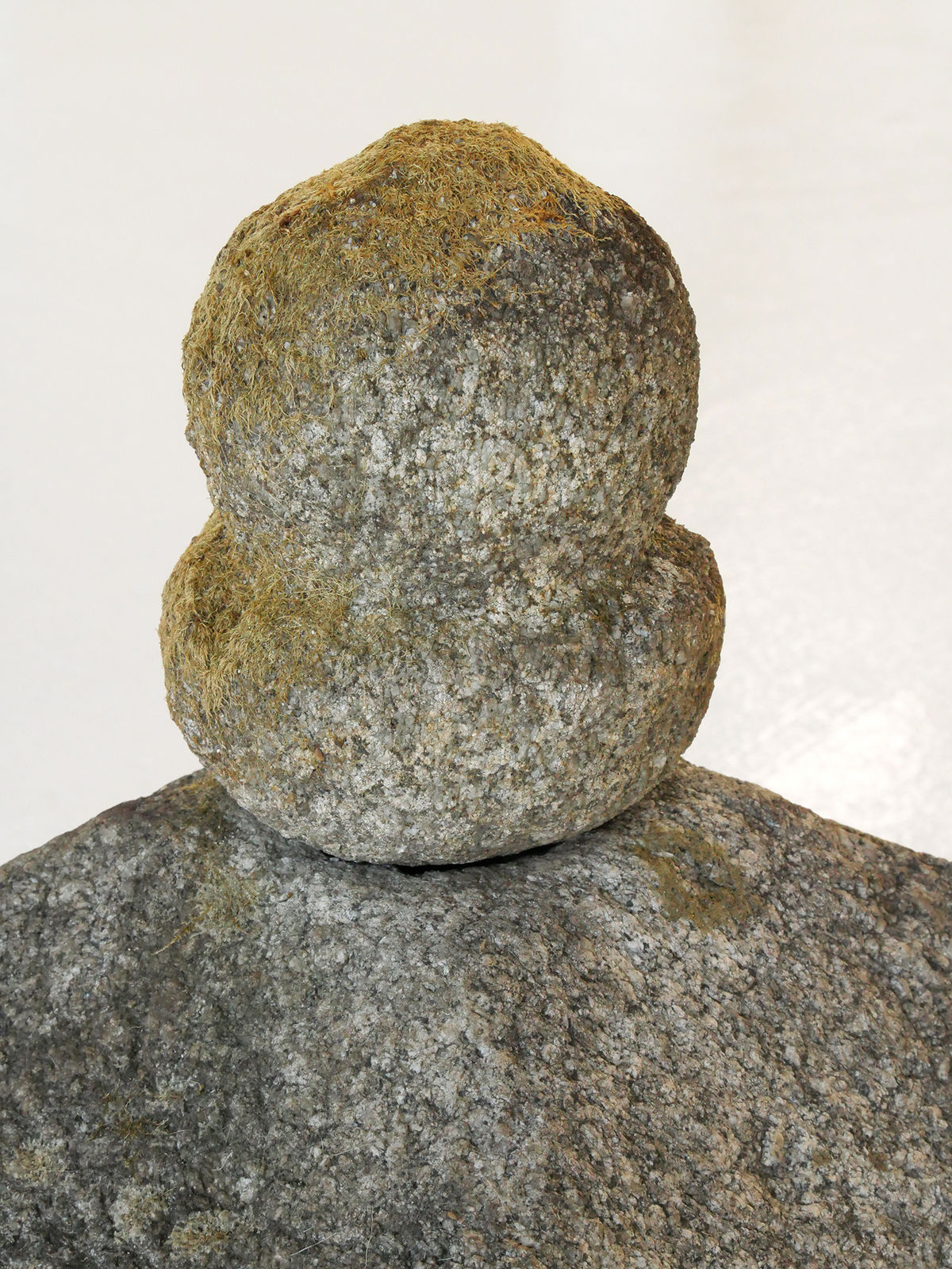 Rounded topper of stone sculpture.