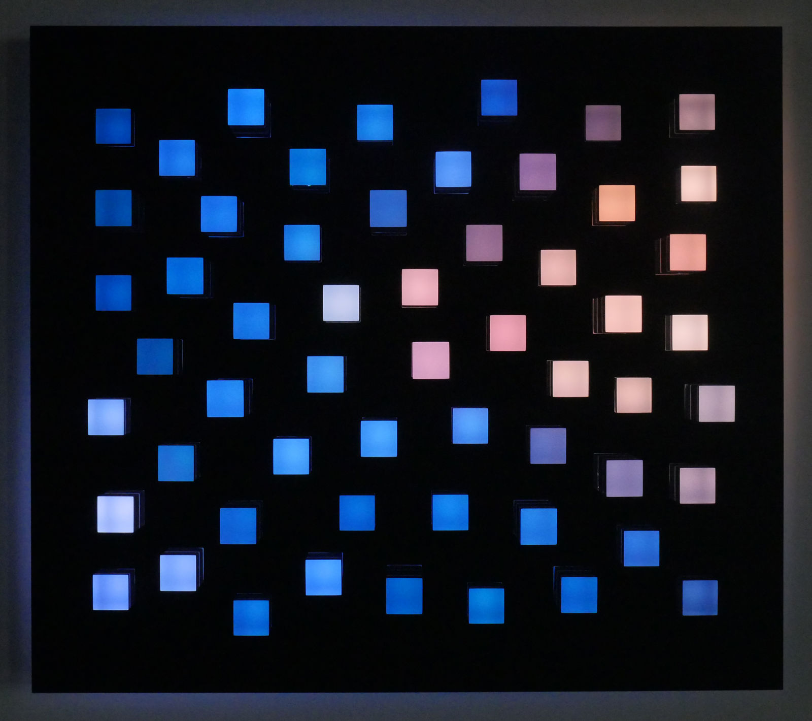 An image of little random square pegs in a black panel of exploded random colors