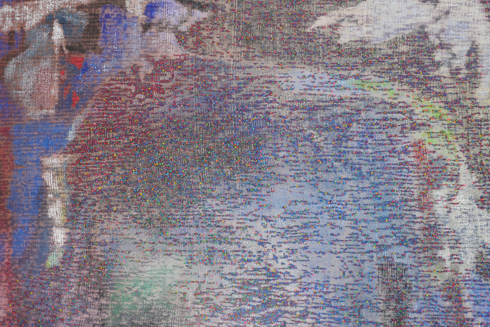 Detail; neon paint protrudes through the back of a multicolored canvas.