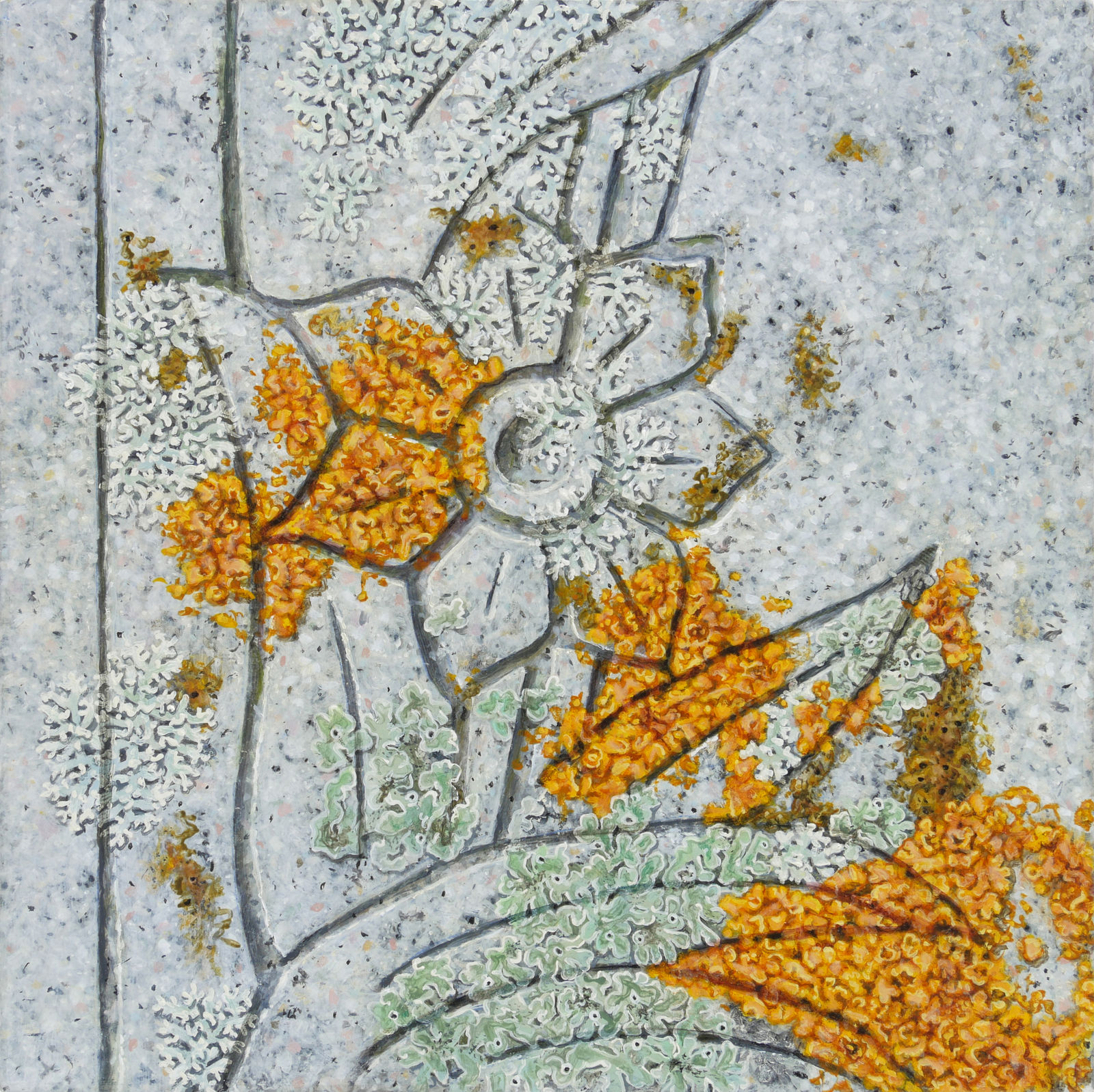 Stone with floral carving and orange and green lichens.