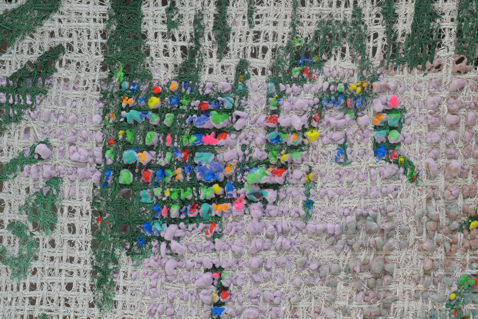 Detail; florescent nubs poke through the canvas and the green and white background.