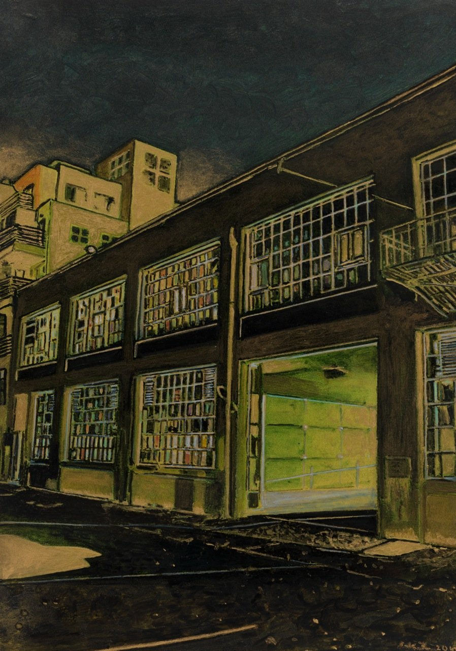 In sepia tones, industrial building with large multi-colored glass windows and open garage is deserted underneath the night sky. Other buildings peek out from behind.
