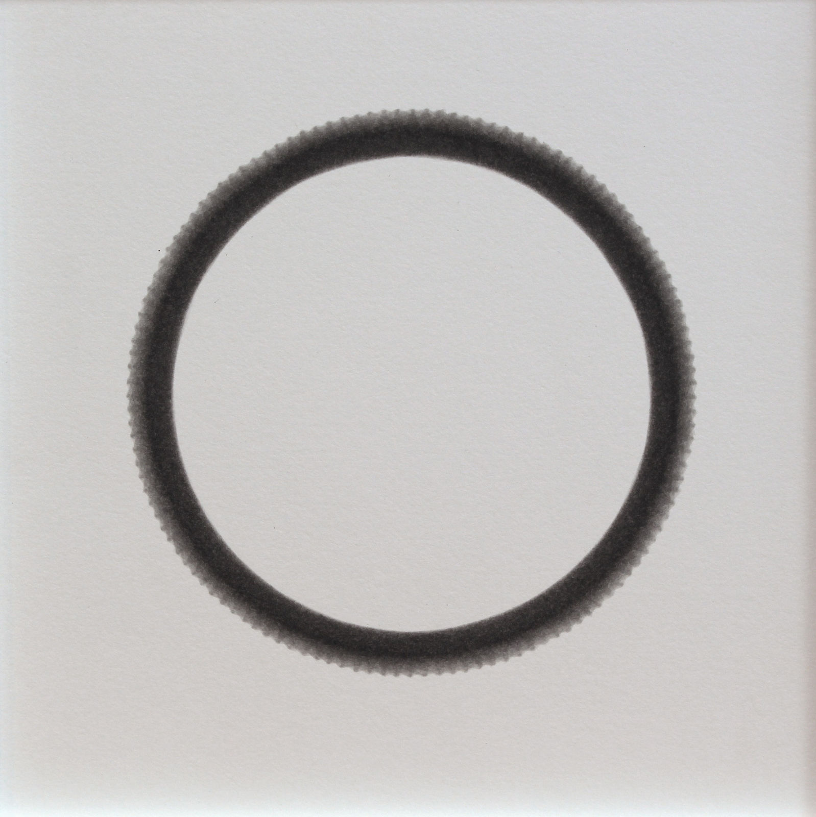 Thin scalloped black ring white center against white background.