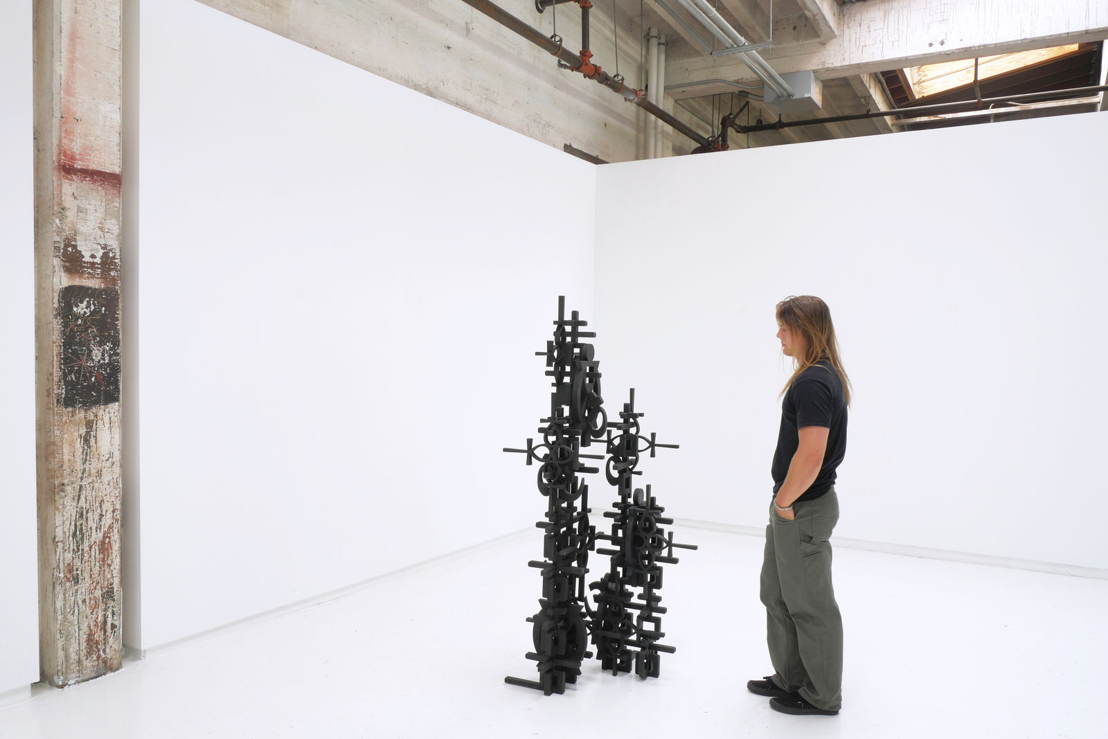 Installation view of Totem with a white man admiring it