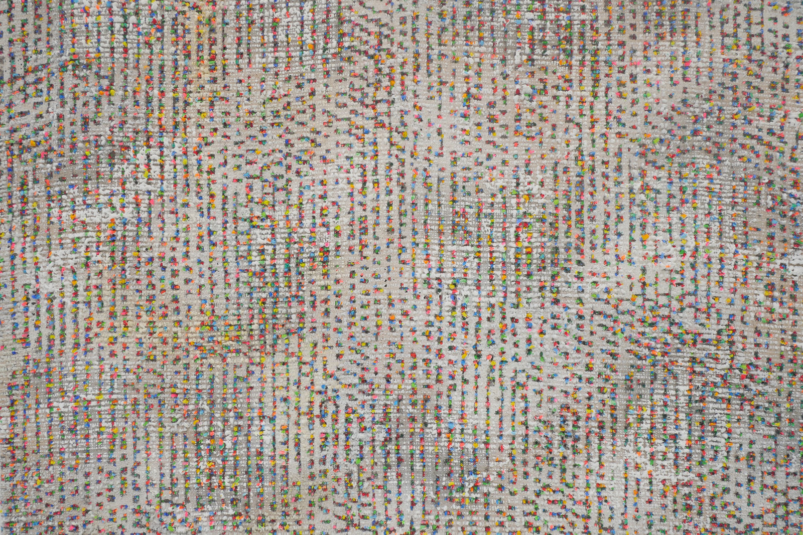 Detail; multicolored neon dots on a beige background.