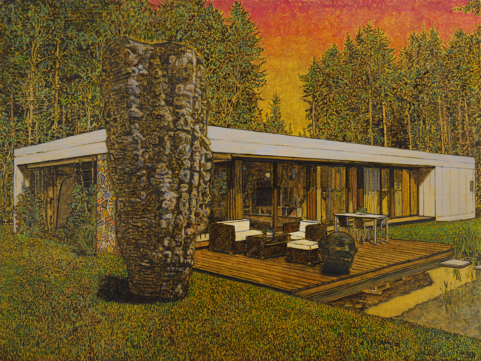 Single-story modern house with glass and white exterior. In front is a patio with outdoor furniture, a stone sculpture of a head, and grass with another large stone sculpture. Trees loom in the background with orange and yellow sky.