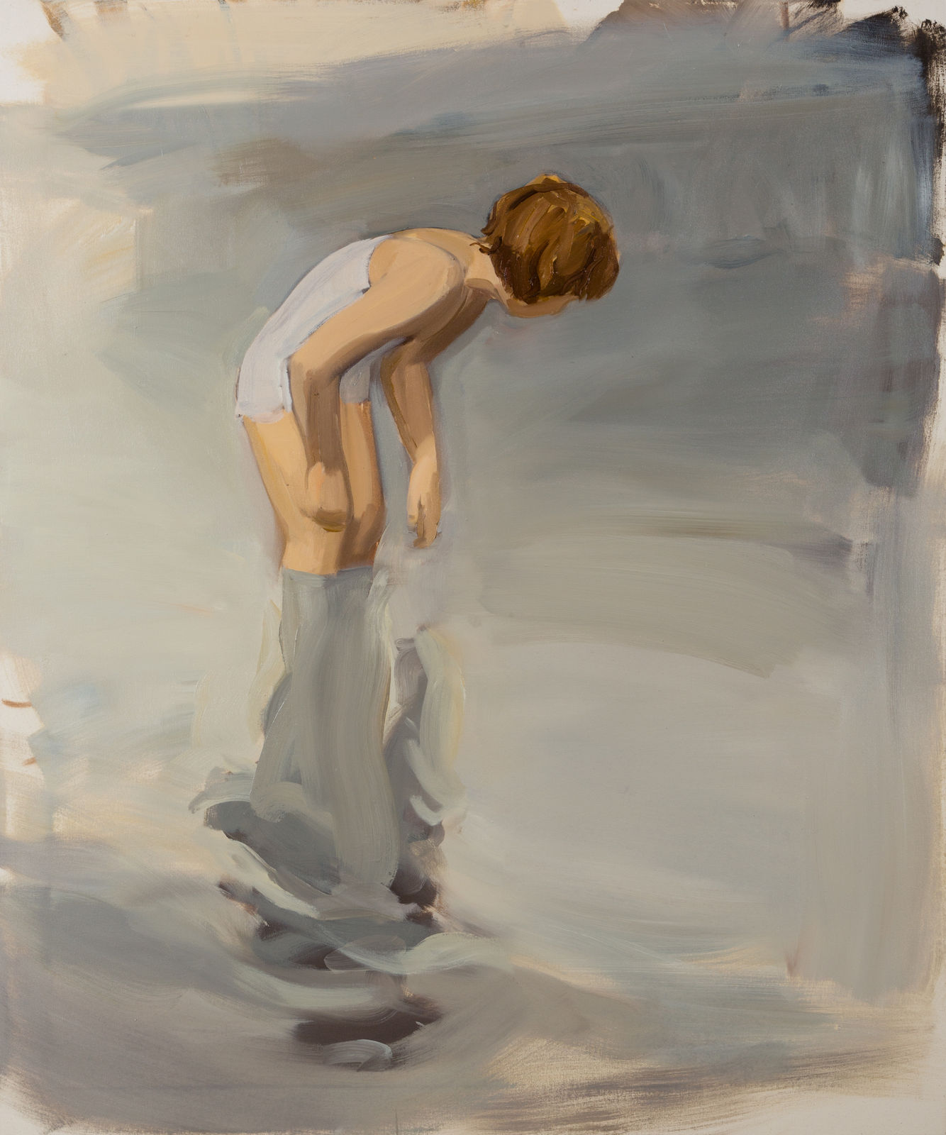 Child in bathing suit stands knee-deep in reflective water and hunches over to look at something in the water.