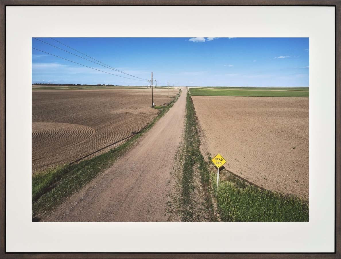 Dirt road with blue sky and Dead End sign in Harrisburg Nebraska by Stephen Shore