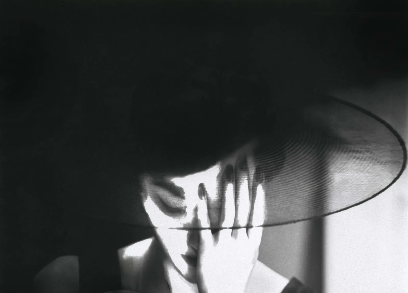 Model Mary Jane Russell in translucent hat by Lillian Bassman for New York, Harper's Bazaar