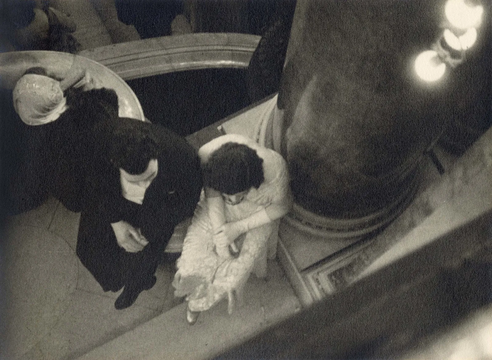 Ilse Bing photograph looking down on man and woman in black tie sitting down