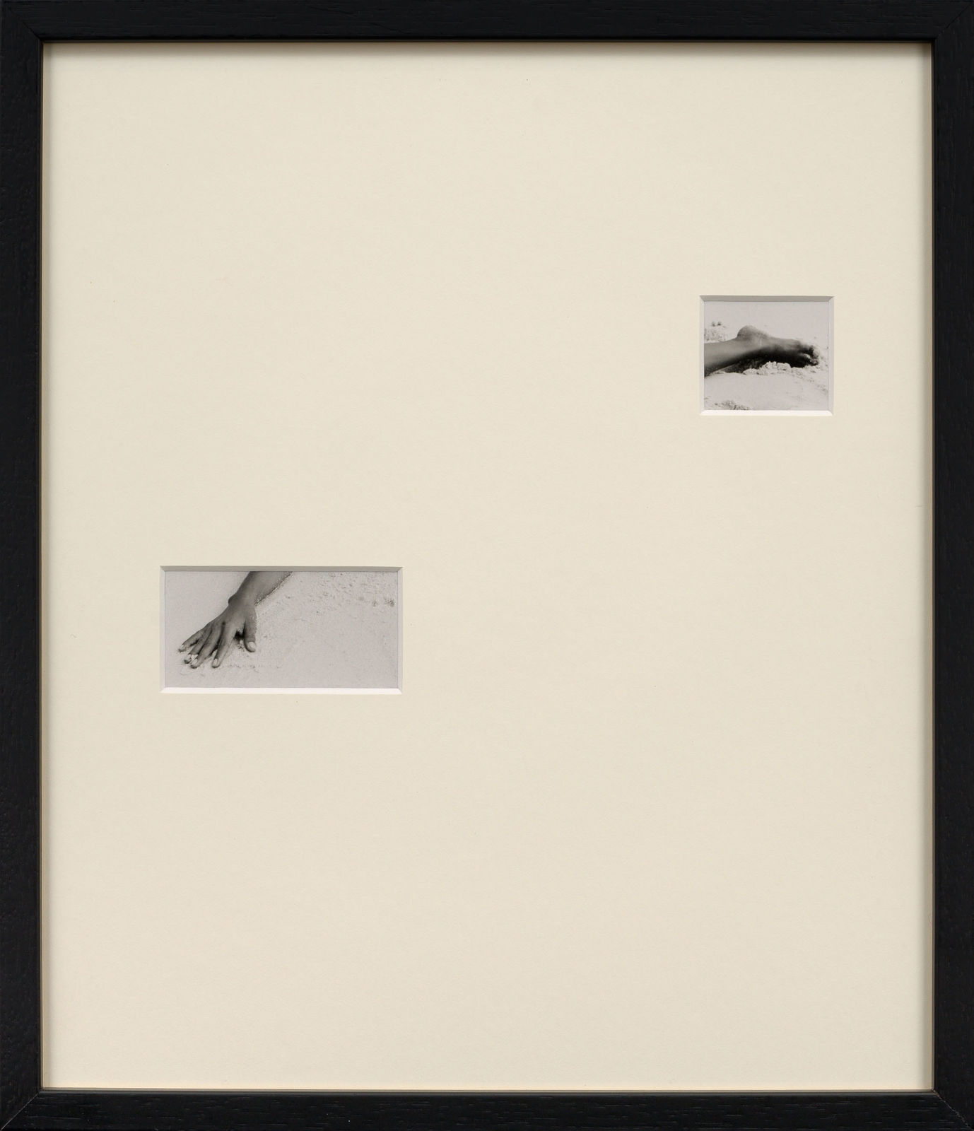 Framed photograph with overmat and cutouts showing a photograph of a hand and foot by Sissi Farassat