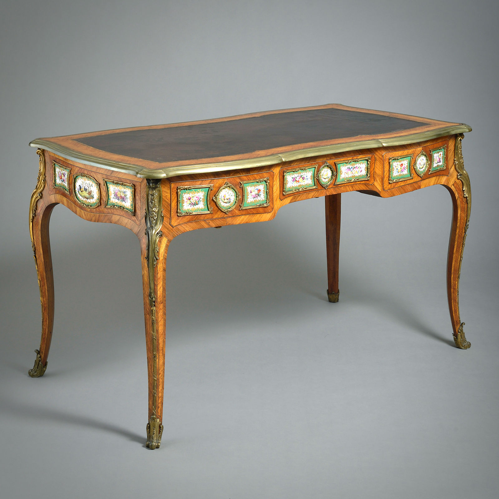 EARLY VICTORIAN PORCELAIN AND ORMOLU-MOUNTED KINGWOOD BUREAU-PLAT