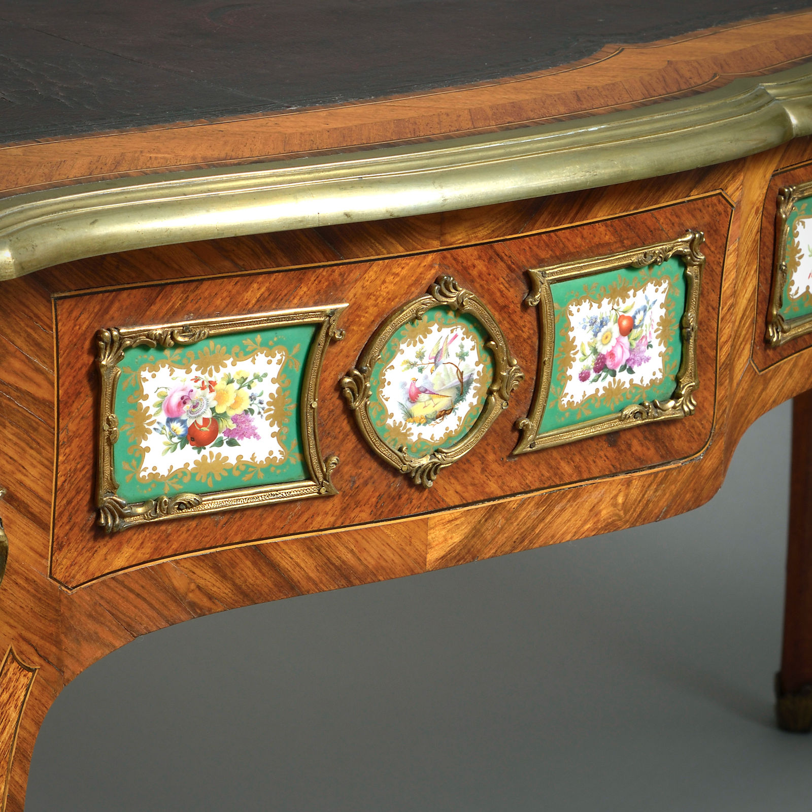 EARLY VICTORIAN PORCELAIN AND ORMOLU-MOUNTED KINGWOOD BUREAU-PLAT