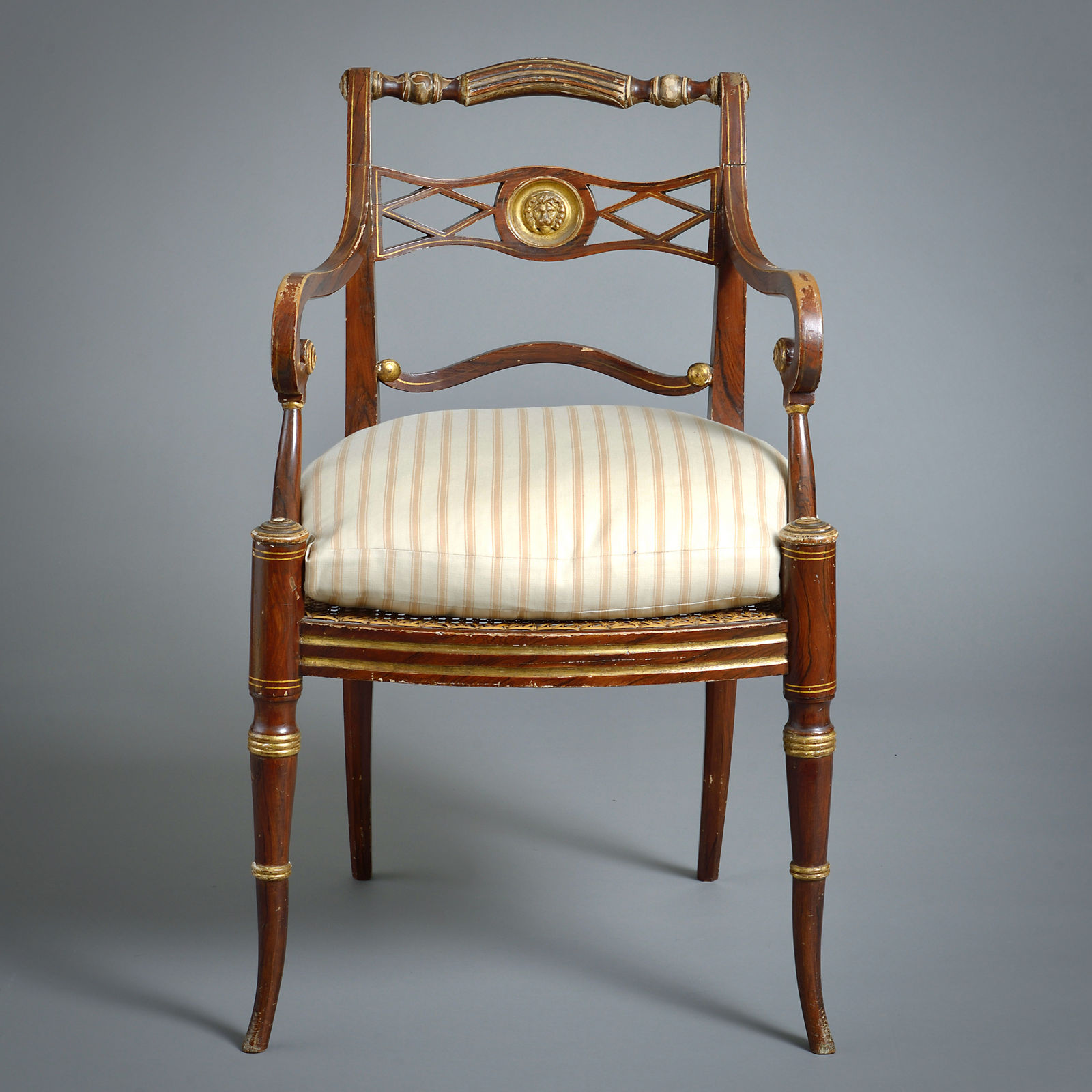 PAIR OF REGENCY GRAINED AND PARCEL-GILT OPEN ARMCHAIRS