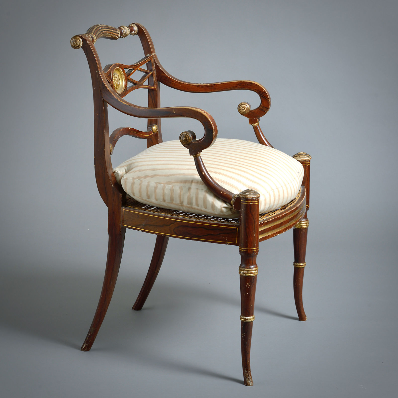 PAIR OF REGENCY GRAINED AND PARCEL-GILT OPEN ARMCHAIRS