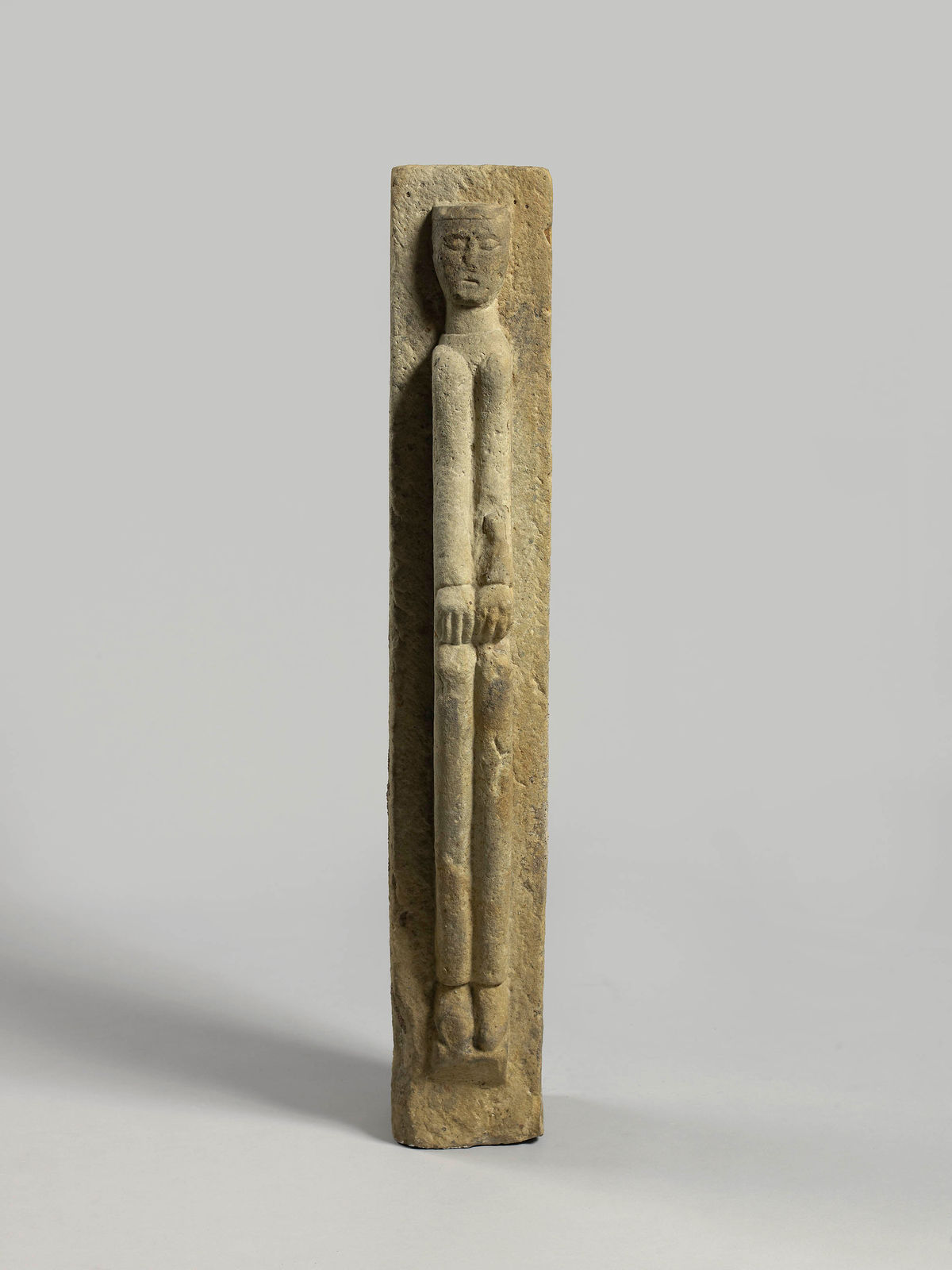 A full-length figure of a man with his hands on his knees, 11th Century Burgundy