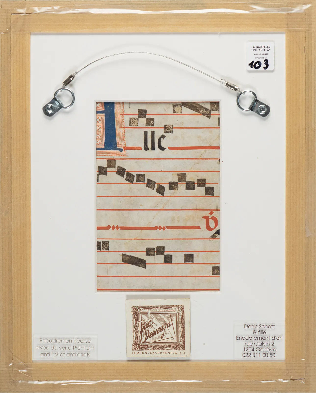 Verso view of a 20th-century Spanish Forger manuscript leaf, showing original Latin text on 15th-century parchment, musical notation, framed with gallery labels from La Gabrielle Fine Arts SA, Geneva, Switzerland.