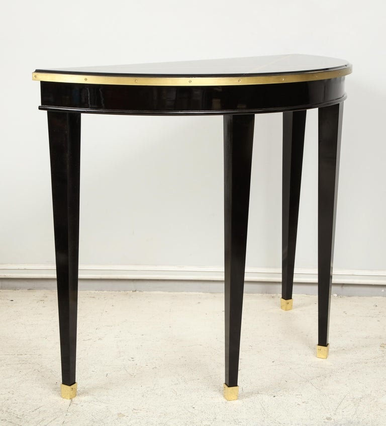 Custom Pair of Ebonized Demilune Consoles with Inlaid Brass Top
