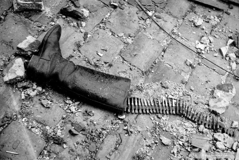 Lee Miller, Debris on pavement outside, [Boot and ammunition], St Malo, France, 1944