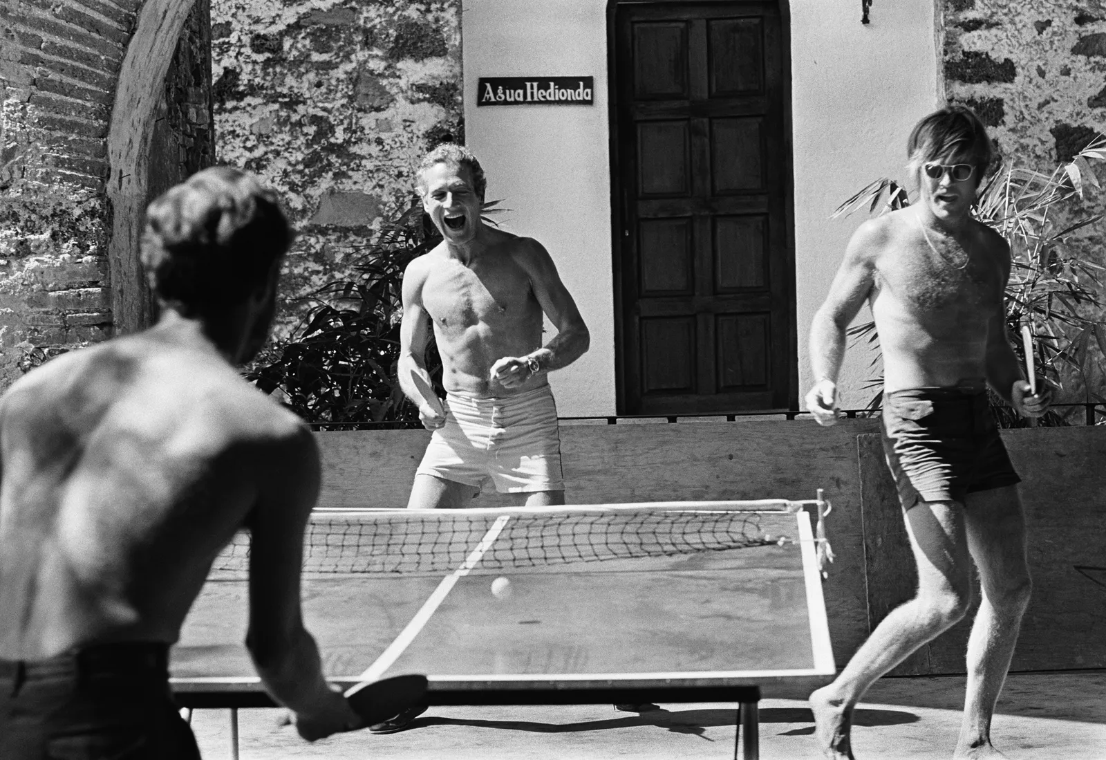 Lawrence Schiller, Paul Newman and Robert Redford playing ping pong on location during the filming of Butch Cassidy and the Sundance Kid in Mexico, 1968