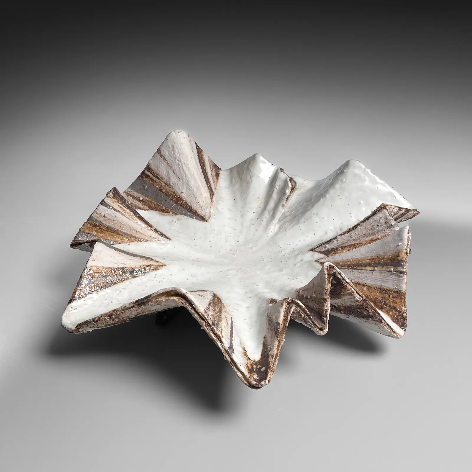 KOIKE SHŌKO, Low pleated shell-shaped vessel with white, iron-oxide, silver, and purple glazes, 1996