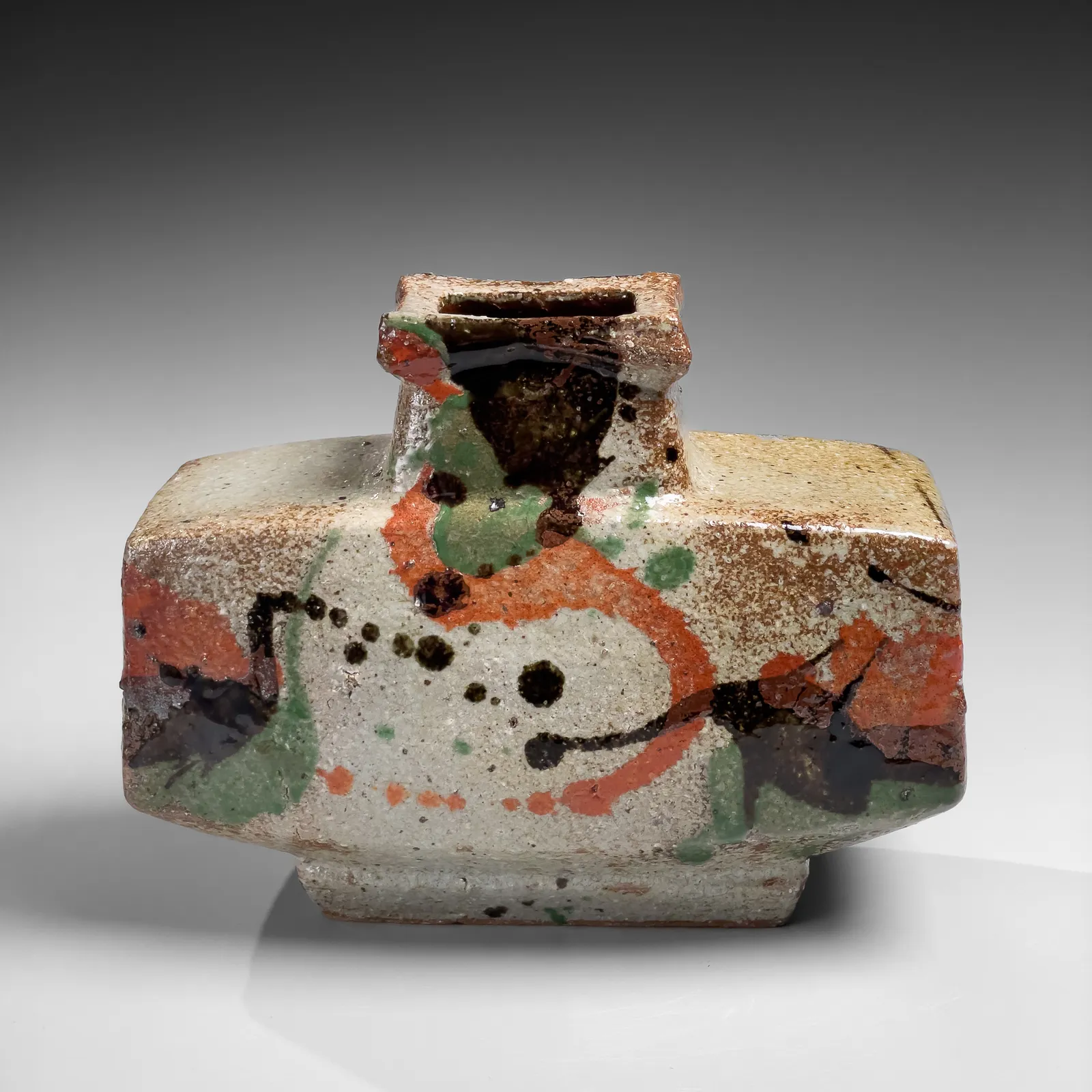 KAWAI KANJIRŌ, Flattened wide rectangular vessel with raised mouth decorated with sançai glazing, ca. 1960